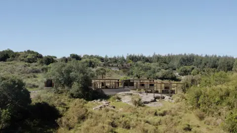 Wooden lodge in grassy hills